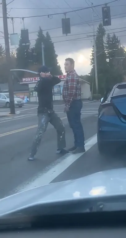 Man Digs Through Trunk at Intersection