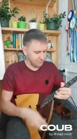 Мужчина зажигает на балалайке
