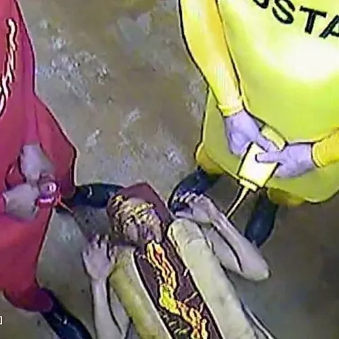 Costumed People Examining Something