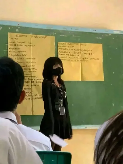 Masked Woman Presenting in Class