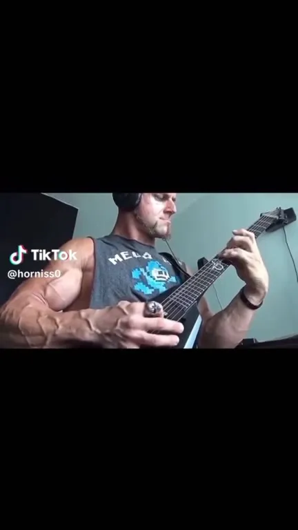 Muscular Man Plays Guitar