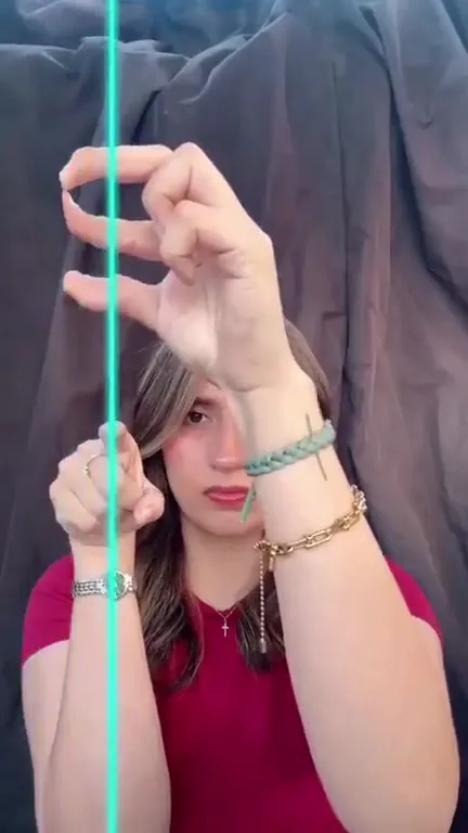 Woman spells PAY with her hands
