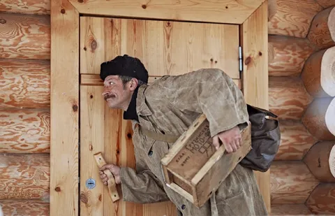 Man Sneaking With a Wooden Crate