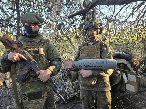 Soldiers Inscribe a Mortar Shell