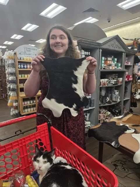 Woman Holds Cowhide in Store