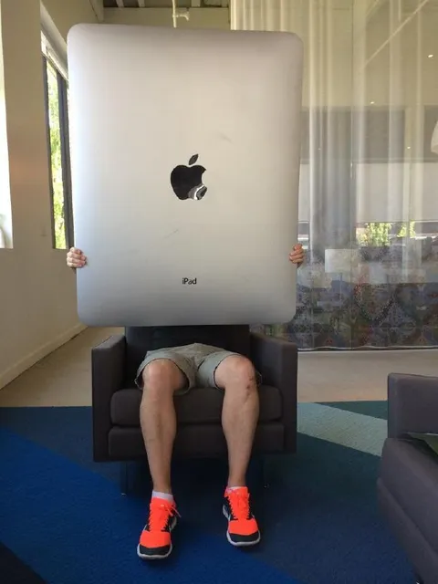 Man Hiding Behind an iPad