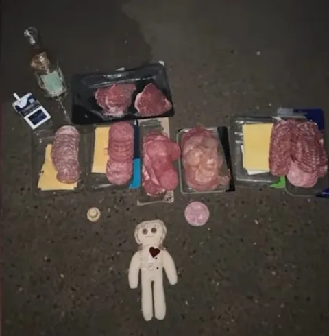 Кукла среди мясной нарезки