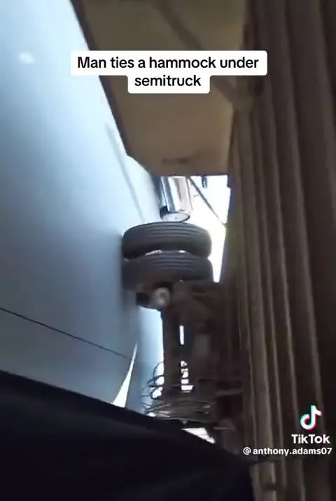 Man in a Hammock Under a Semi Truck