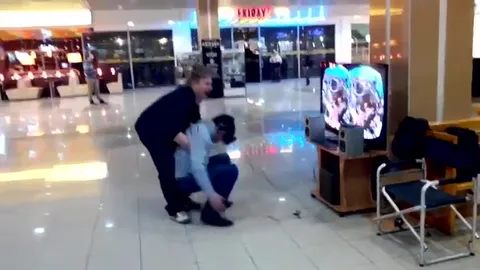 Man Falls at Arcade Machine